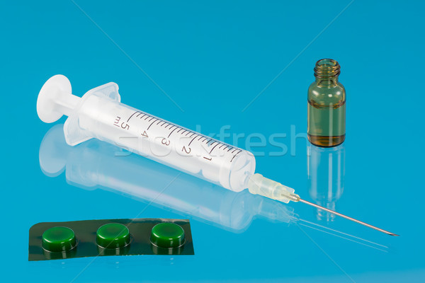 Syringe and tablets and a vial with a serum Stock photo © manfredxy