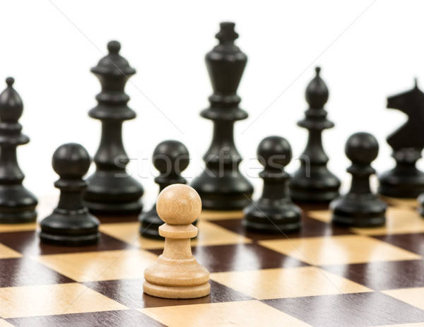 White pawn against a superiority of black chess pieces Stock photo © manfredxy
