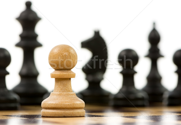 White pawn against a superiority of black chess pieces Stock photo © manfredxy