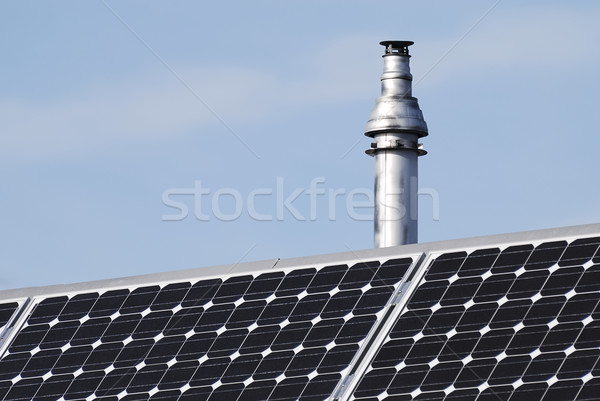 Stock photo: Chimney and photovoltaic cells