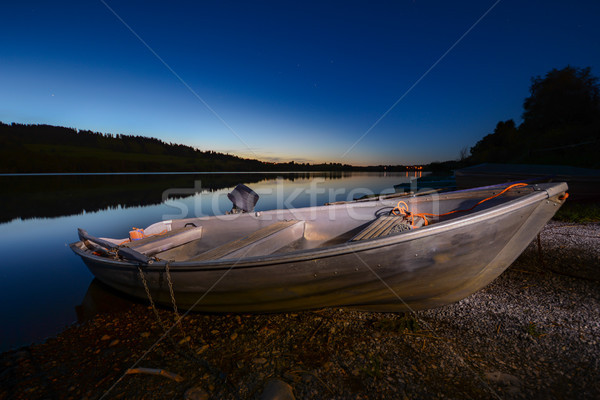 Illuminated rowboats at a lake at night Stock photo © manfredxy