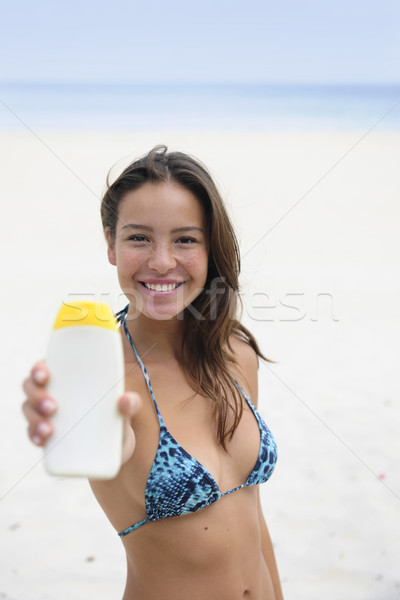 woman showing suncream at the beach Stock photo © mangostock