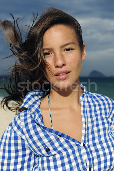 wind: woman with tousled hair at the sea  Stock photo © mangostock