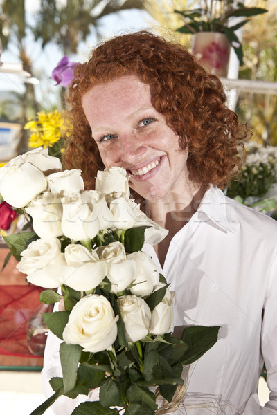 Woman buying flowers in a flower store Stock photo © mangostock