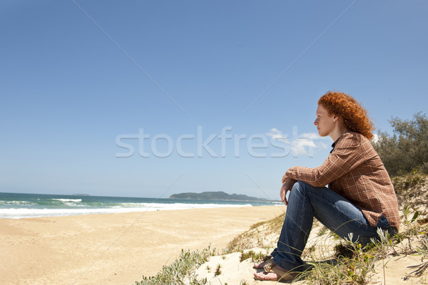 pensive woman sitting on the dunes Stock photo © mangostock