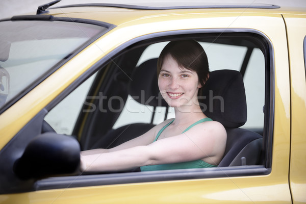 Happy woman in her new car Stock photo © mangostock