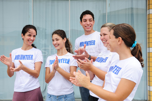 Stock photo: happy volunteer group applauding