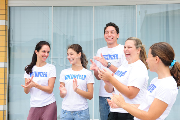 Stock photo: happy volunteer group applauding