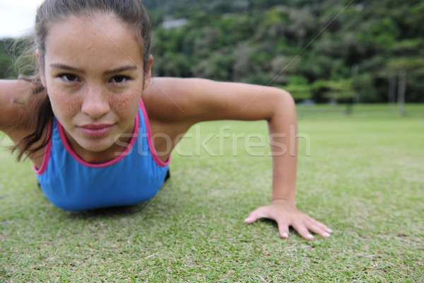 sporty woman doing push-ups Stock photo © mangostock