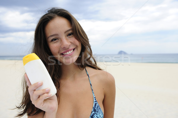 woman showing suncream at the beach Stock photo © mangostock