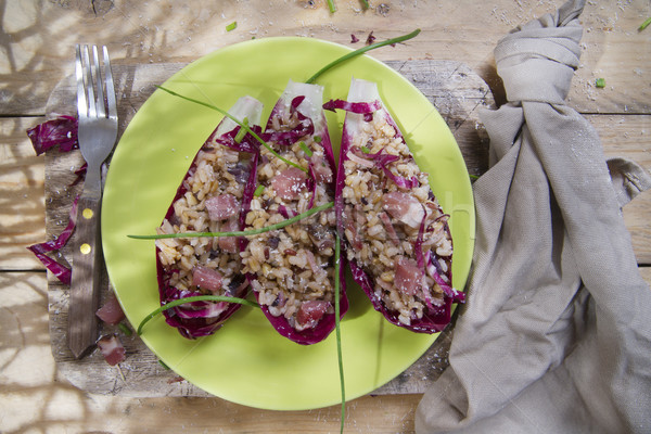 Boat of brown rice with red radicchio and speck Stock photo © marcoguidiph