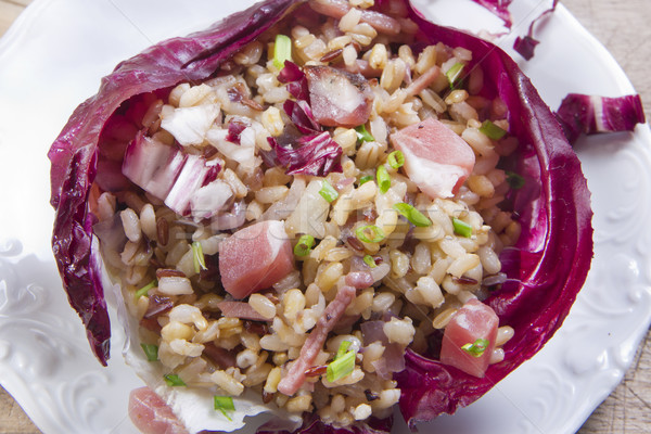 Brown rice with red radicchio and speck Stock photo © marcoguidiph