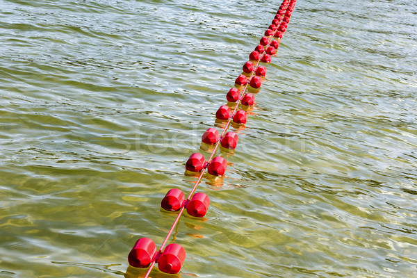 On the waters of the lake floating plastic buoys Stock photo © marekusz