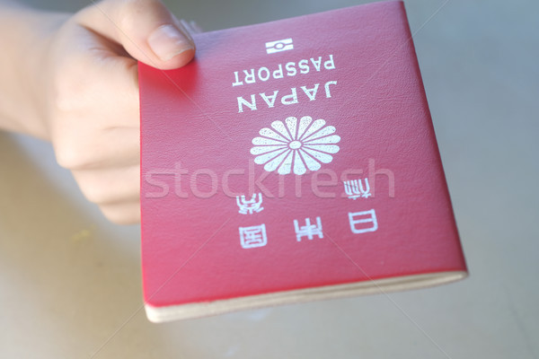 Persons hand holding a passport of Japan Stock photo © Margolana