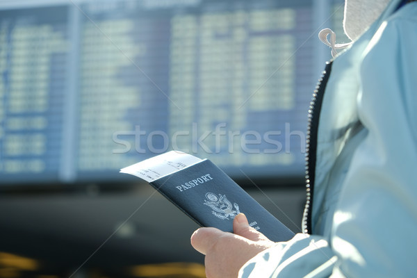 女子 護照 看 出發 板 登機 商業照片 © Margolana