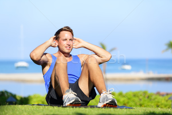 Man exercising sit-ups outside Stock photo © Maridav