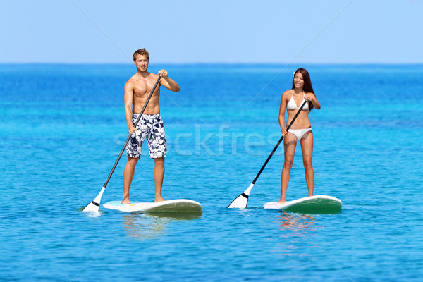 Stand up paddleboard beach people on paddle board Stock photo © Maridav