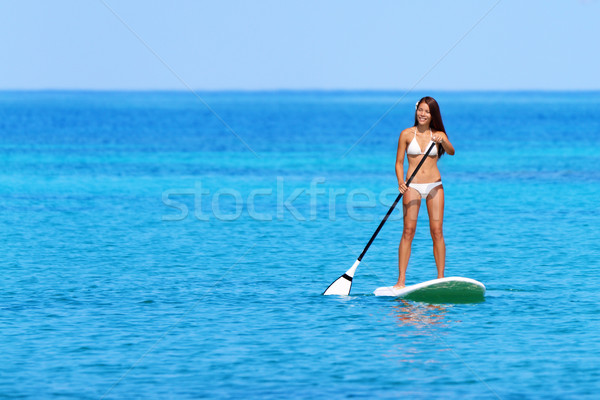 Stand up paddle board woman paddleboarding Stock photo © Maridav