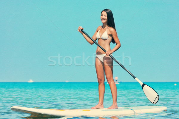 Stand up paddle board woman paddleboarding Stock photo © Maridav