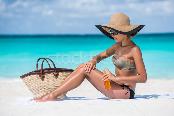 Beach essentials bikini woman putting sunscreen Stock photo © Maridav