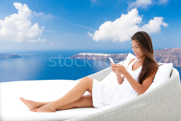 Smartphone woman relaxing on outdoor sofa Stock photo © Maridav