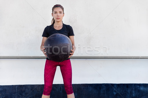 Fitness gym woman training arms with medicine ball Stock photo © Maridav