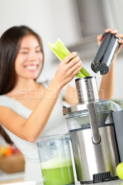 Vegetable juice - woman juicing green vegetables Stock photo © Maridav