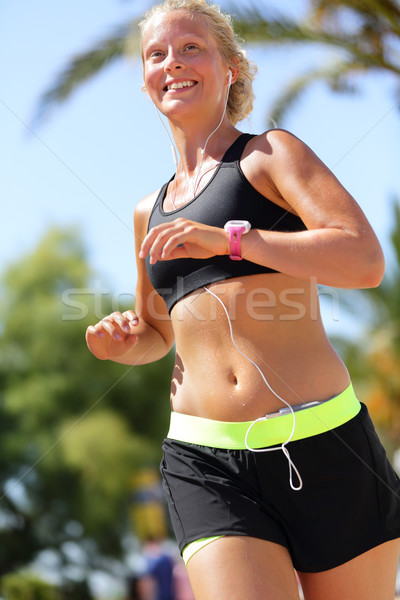 Runner running wearing smartphone and smartwatch Stock photo © Maridav