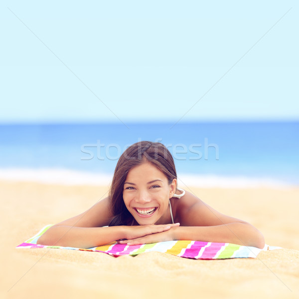 Happy vacation woman sunbathing relaxing on beach Stock photo © Maridav