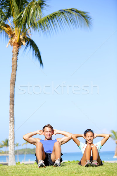 People training sit ups outside - fitness couple Stock photo © Maridav