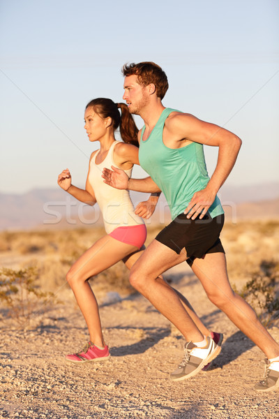 Runners couple running in trail run outside Stock photo © Maridav