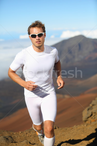 Athletic man running cross-country Stock photo © Maridav