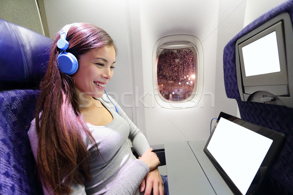Plane passenger in airplane using tablet computer Stock photo © Maridav