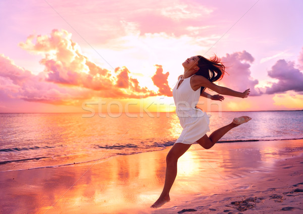 Happy beautiful woman running at beach sunset Stock photo © Maridav