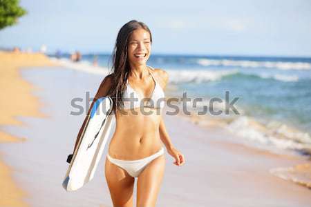 Surfer girl surfing walking with surfboard Waikiki Stock photo © Maridav