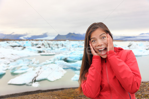 Excited happy woman at glacier lagoon on Iceland Stock photo © Maridav