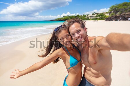 Sexy suntan interracial couple walking on beach Stock photo © Maridav