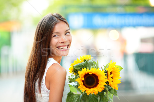 Stock photo: Woman holding sunflower flower smiling happy