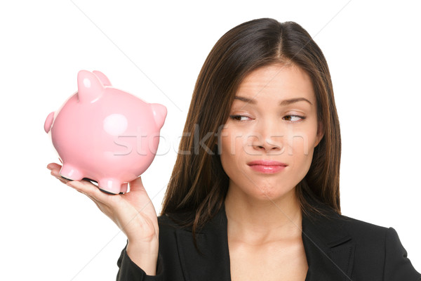 Piggy bank savings with unhappy funny woman Stock photo © Maridav