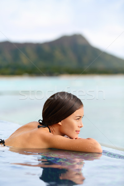 Vacation woman relaxing at pool spa hotel resort Stock photo © Maridav