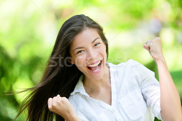 Successful Young Woman With Clenched Fists In Park Stock photo © Maridav