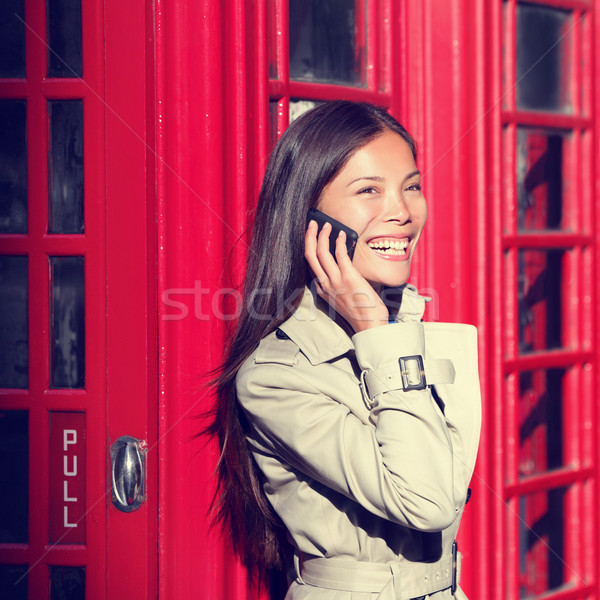 London woman on smart phone by red phone booth Stock photo © Maridav