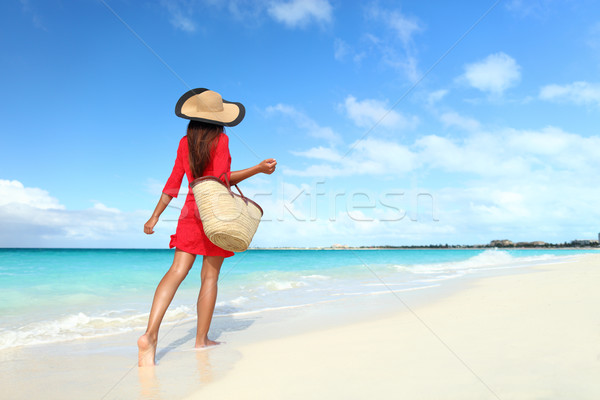 Beachwear woman walking with sun hat and beach bag Stock photo © Maridav