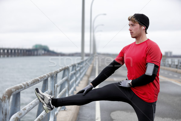 Winter fitness running man warm-up stretching legs Stock photo © Maridav