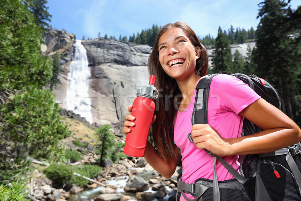 Healthy hiker girl drinking water in nature hike Stock photo © Maridav