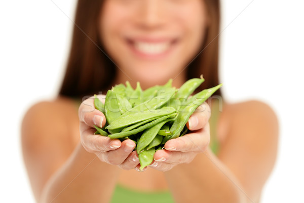Woman holding fresh green snow peas in hands Stock photo © Maridav