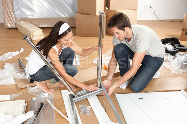 Couple moving in together assembling furniture table Stock photo © Maridav