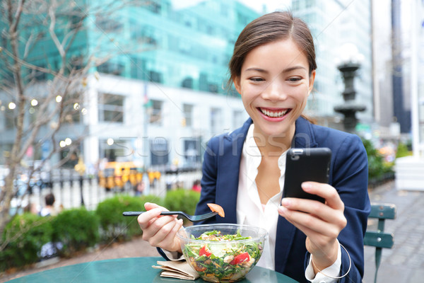 Young business woman eating salad on lunch break Stock photo © Maridav