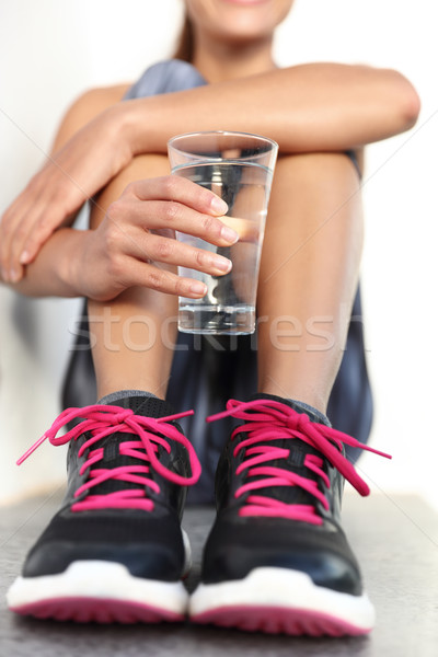 Fitness athlete drinking water holding glass hydration concept Stock photo © Maridav