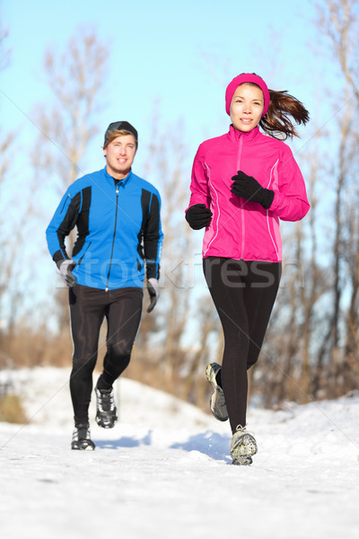 Young couple jogging in winter snow Stock photo © Maridav